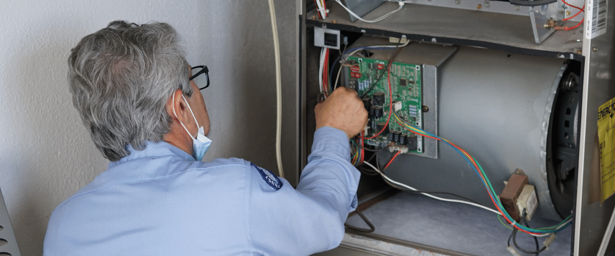 Brody Pennell technician repairing furnace